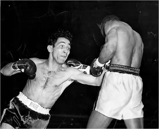 Vintage boxing match with boxer delivering a punch