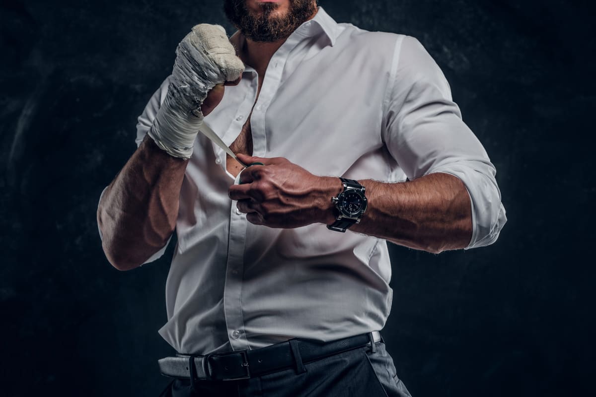 Boxer with adhesive taped up hands and a beard